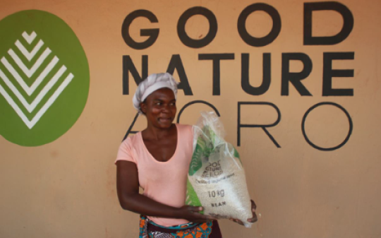 A woman carrying a bag of beans