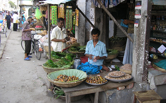 A man selling vegetables at market in Asia